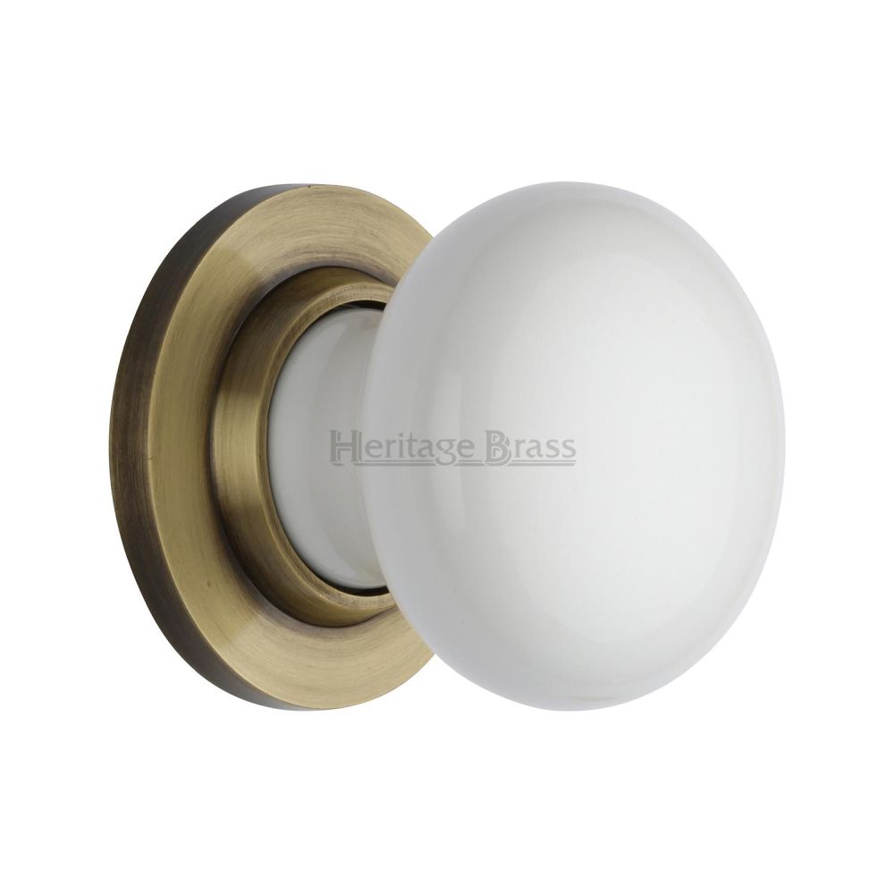 This is an image of a Heritage Brass - White Knob with Antique Brass base, 5010-at that is available to order from T.H Wiggans Ironmongery in Kendal.