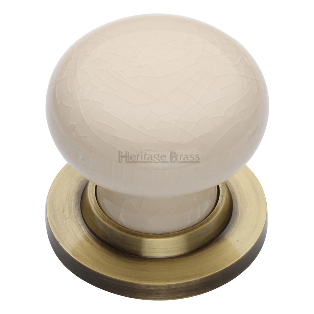 This is an image of a Heritage Brass - Cream Crackle Knob with Antique Brass base, 8010-at that is available to order from T.H Wiggans Ironmongery in Kendal.