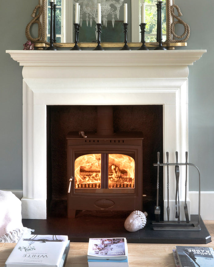 Image showing a fire place with a From The Anvil companion set that is available to order from T.H Wiggans Ironmongery in Kendal