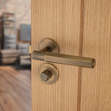 This is an image showing Alexander & Wilks - Spitfire Hex Lever on Round Rose - Italian Brass aw224ib available to order from T.H. Wiggans Ironmongery in Kendal, quick delivery and discounted prices.