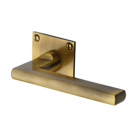 This is an image of a Heritage Brass - Door Handle Lever Latch on Square Rose Trident Design Antique finish, bau2910-at that is available to order from T.H Wiggans Ironmongery in Kendal.