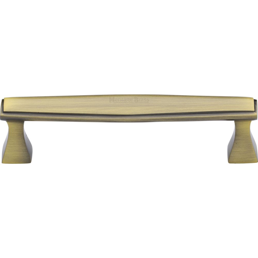 This is an image of a Heritage Brass - Cabinet Pull Deco Design 128mm CTC Antique Brass Finish, c0334-128-at that is available to order from T.H Wiggans Ironmongery in Kendal.