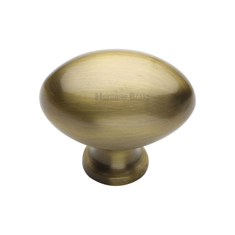 This is an image of a Heritage Brass - Cabinet Knob Victorian Oval Design 38mm Antique Brass Finish, c114-38-at that is available to order from T.H Wiggans Ironmongery in Kendal.