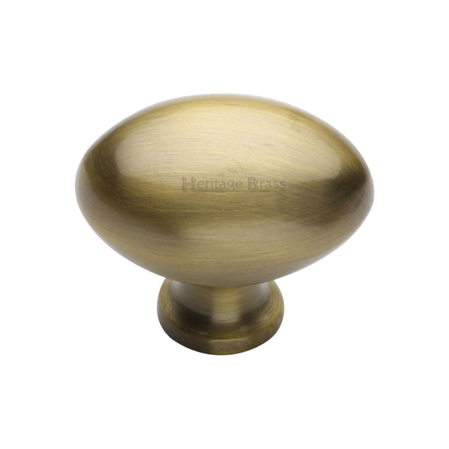 This is an image of a Heritage Brass - Cabinet Knob Victorian Oval Design 38mm Antique Brass Finish, c114-38-at that is available to order from T.H Wiggans Ironmongery in Kendal.