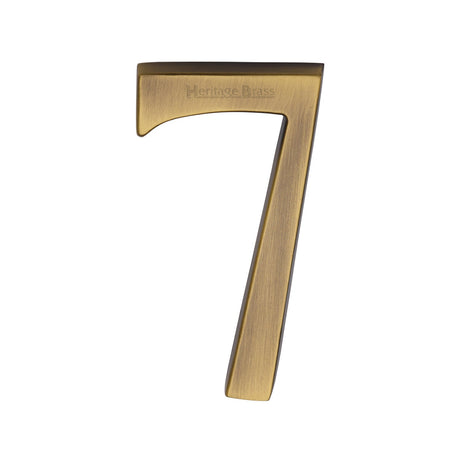 This is an image of a Heritage Brass - Numeral 7 Concealed Fix 76mm (3") Antique Brass finish, c1564-7-at that is available to order from T.H Wiggans Ironmongery in Kendal.