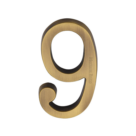 This is an image of a Heritage Brass - Numeral 9 Concealed Fix 76mm (3) Antique Brass finish, c1564-9-at that is available to order from T.H Wiggans Ironmongery in Kendal.