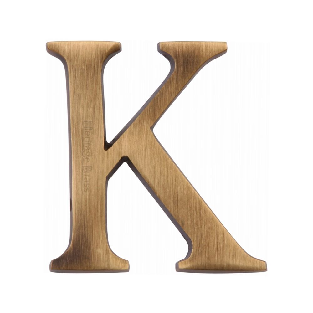 This is an image of a Heritage Brass - Alphabet K Pin Fix 51mm (2") Antique Brass Finish, c1565-2-k-at that is available to order from T.H Wiggans Ironmongery in Kendal.