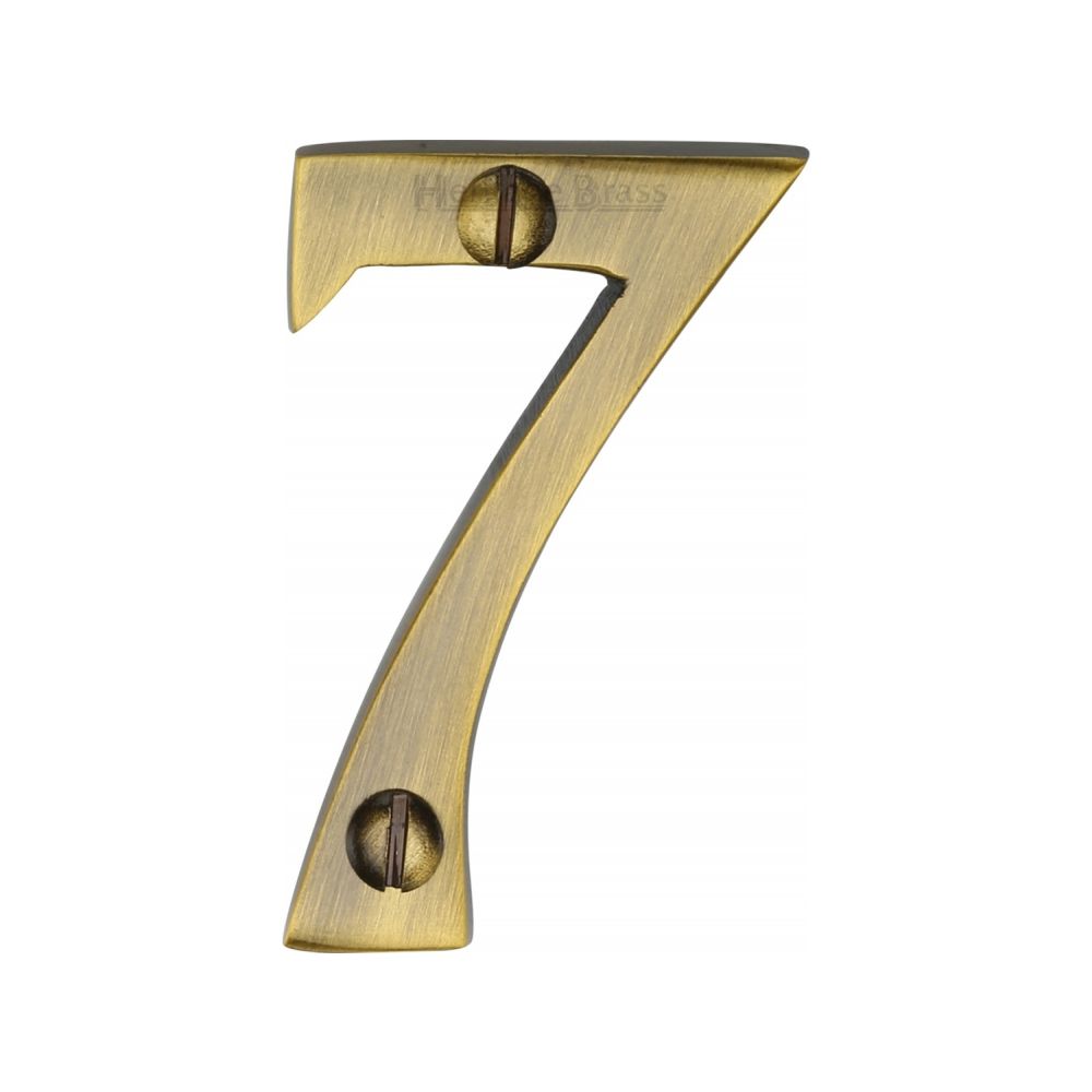 This is an image of a Heritage Brass - Numeral 7 Face Fix 51mm (2") Antique Brass Finish, c1567-7-at that is available to order from T.H Wiggans Ironmongery in Kendal.