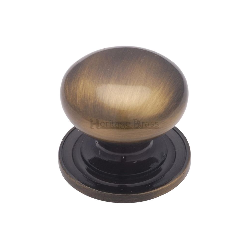 This is an image of a Heritage Brass - Cabinet Knob Victorian Round Design with base 32mm Antique Brass F, c2240-32-at that is available to order from T.H Wiggans Ironmongery in Kendal.