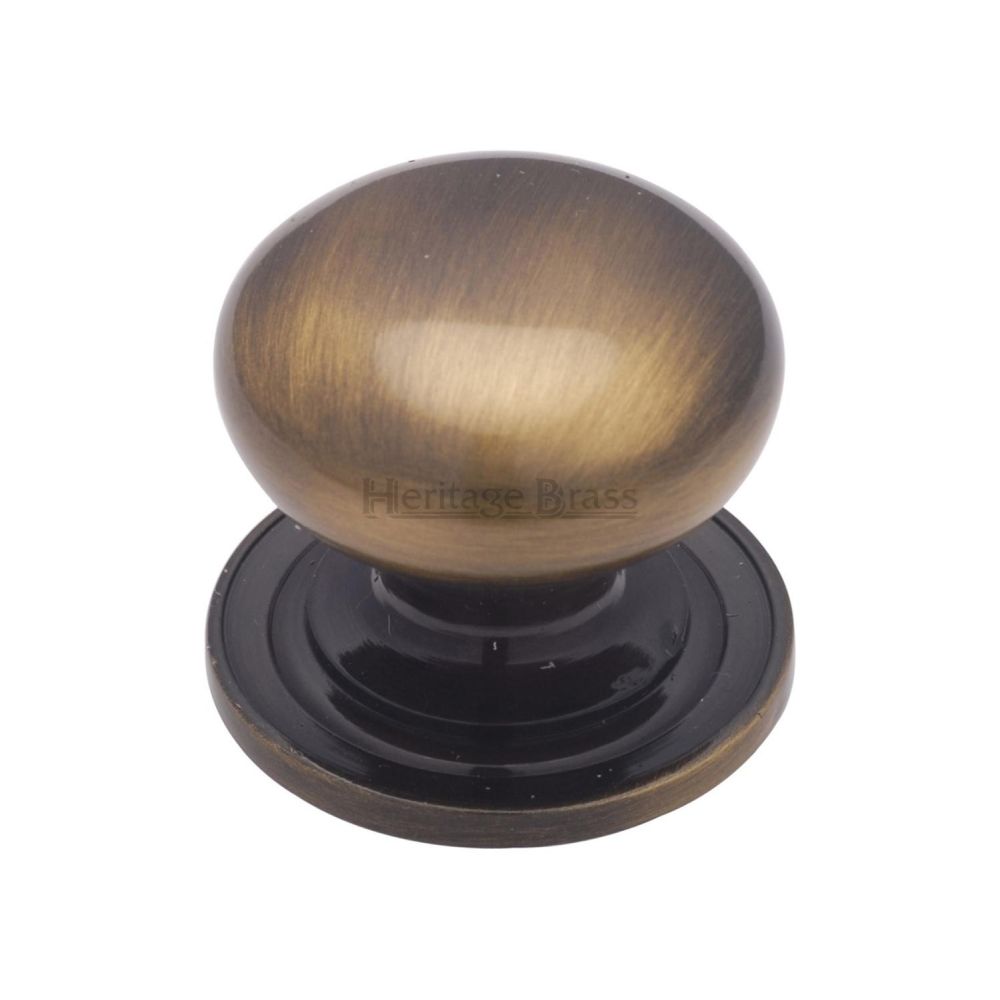 This is an image of a Heritage Brass - Cabinet Knob Victorian Round Design with base 48mm Antique Brass F, c2240-48-at that is available to order from T.H Wiggans Ironmongery in Kendal.