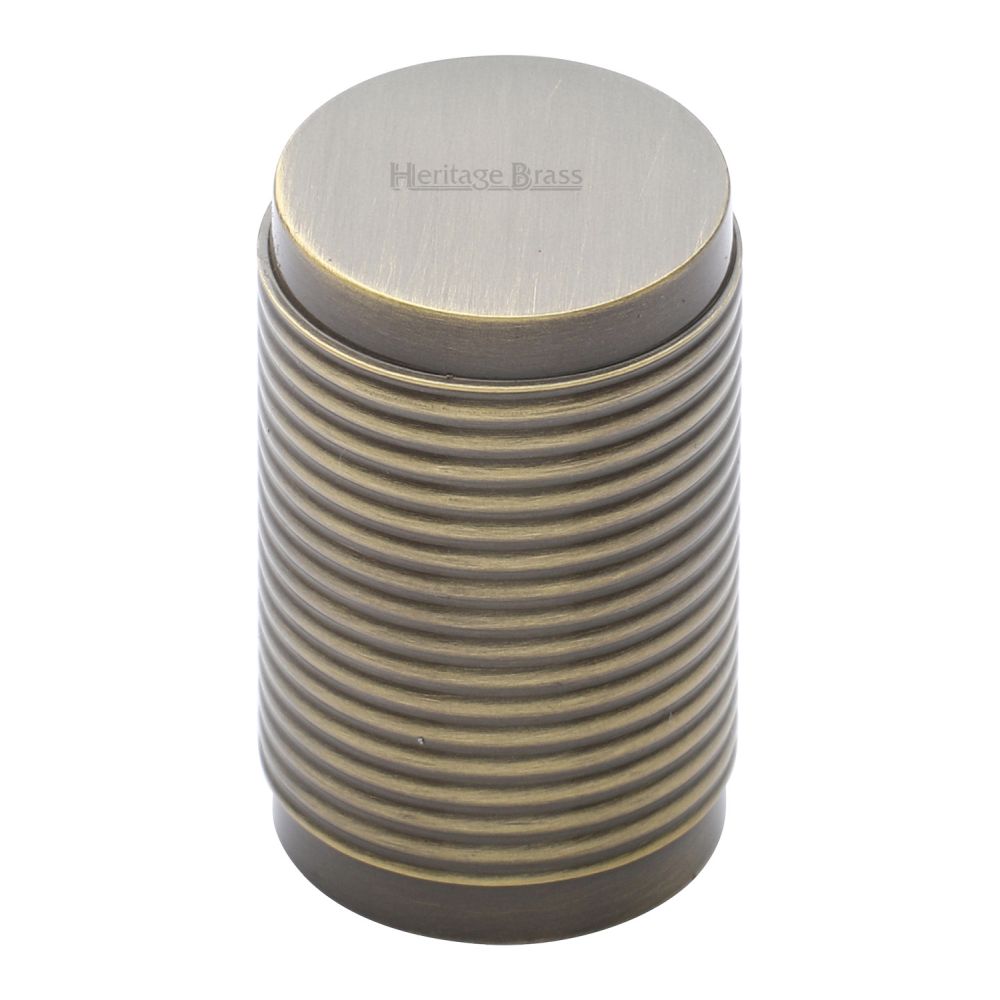 This is an image of a Heritage Brass - Cabinet Knob Cylindric Ribbed Design 21mm Antique Brass Finish, c3850-at that is available to order from T.H Wiggans Ironmongery in Kendal.