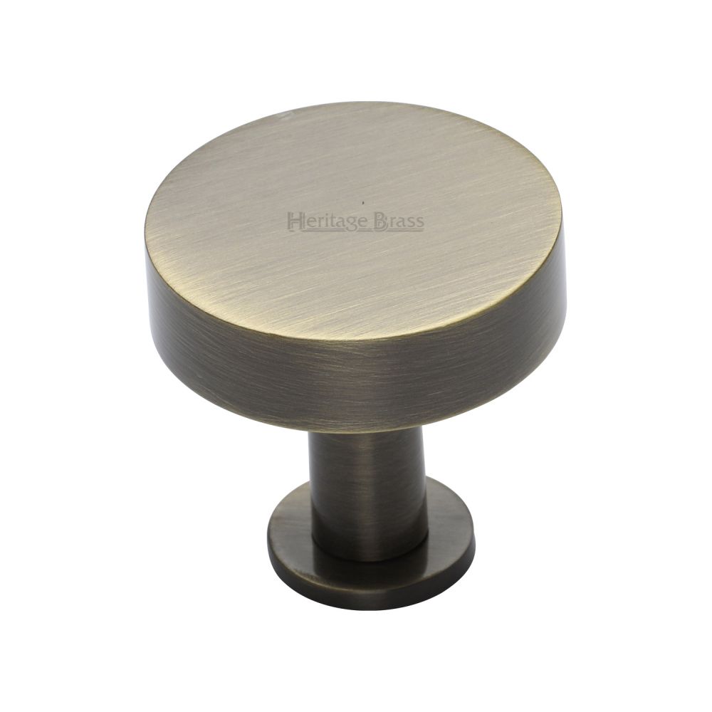 This is an image of a Heritage Brass - Cabinet Knob Disc Design with Rose 32mm Antique Brass Finish, c3885-32-at that is available to order from T.H Wiggans Ironmongery in Kendal.