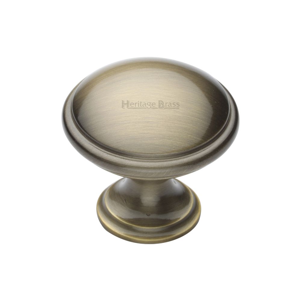 This is an image of a Heritage Brass - Cabinet Knob Domed Design 32mm Antique Brass Finish, c3950-32-at that is available to order from T.H Wiggans Ironmongery in Kendal.