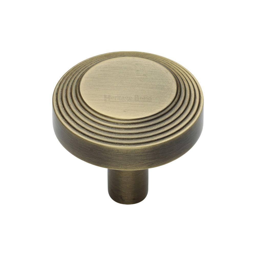 This is an image of a Heritage Brass - Cabinet Knob Ridge Design 32mm Antique Brass Finish, c3956-32-at that is available to order from T.H Wiggans Ironmongery in Kendal.
