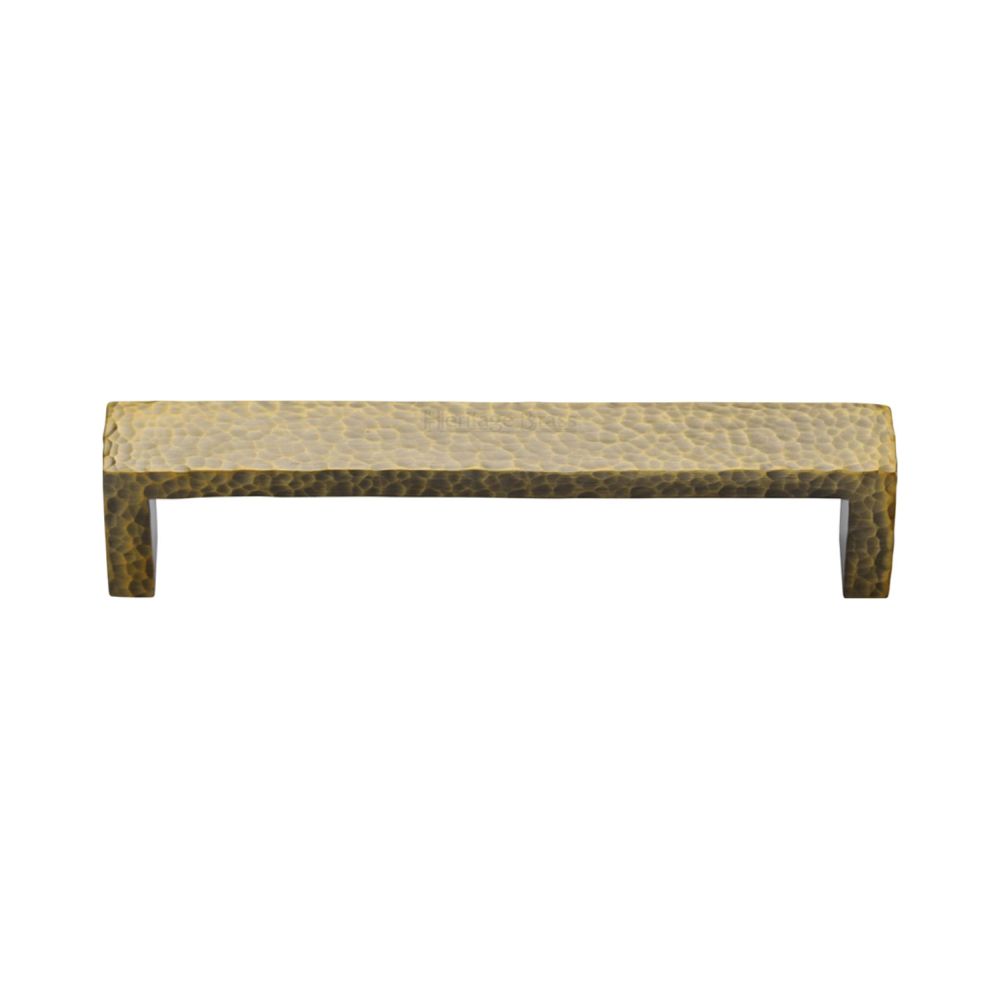 This is an image of a Heritage Brass - Cabinet Pull Hammered Wide Metro Design 128mm CTC Antique Brass Fi, c4525-128-at that is available to order from T.H Wiggans Ironmongery in Kendal.