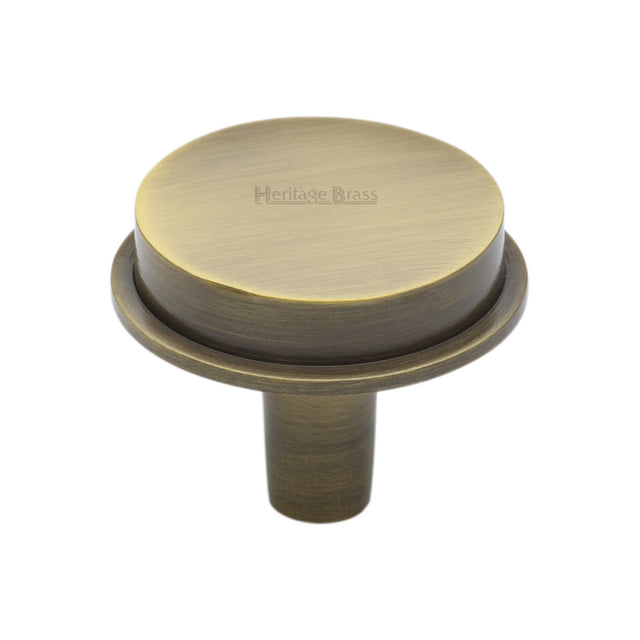This is an image of a Heritage Brass - Flat Round Knob Design 38 mm Antique Brass finish, c4592-38-at that is available to order from T.H Wiggans Ironmongery in Kendal.