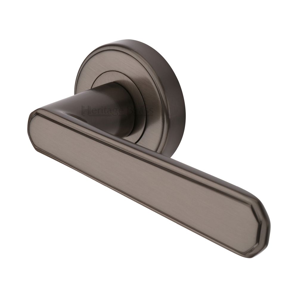 This is an image of a Heritage Brass - Door Handle Lever Latch on Round Rose Century Design Matt Bronz, cen1924-mb that is available to order from T.H Wiggans Ironmongery in Kendal.