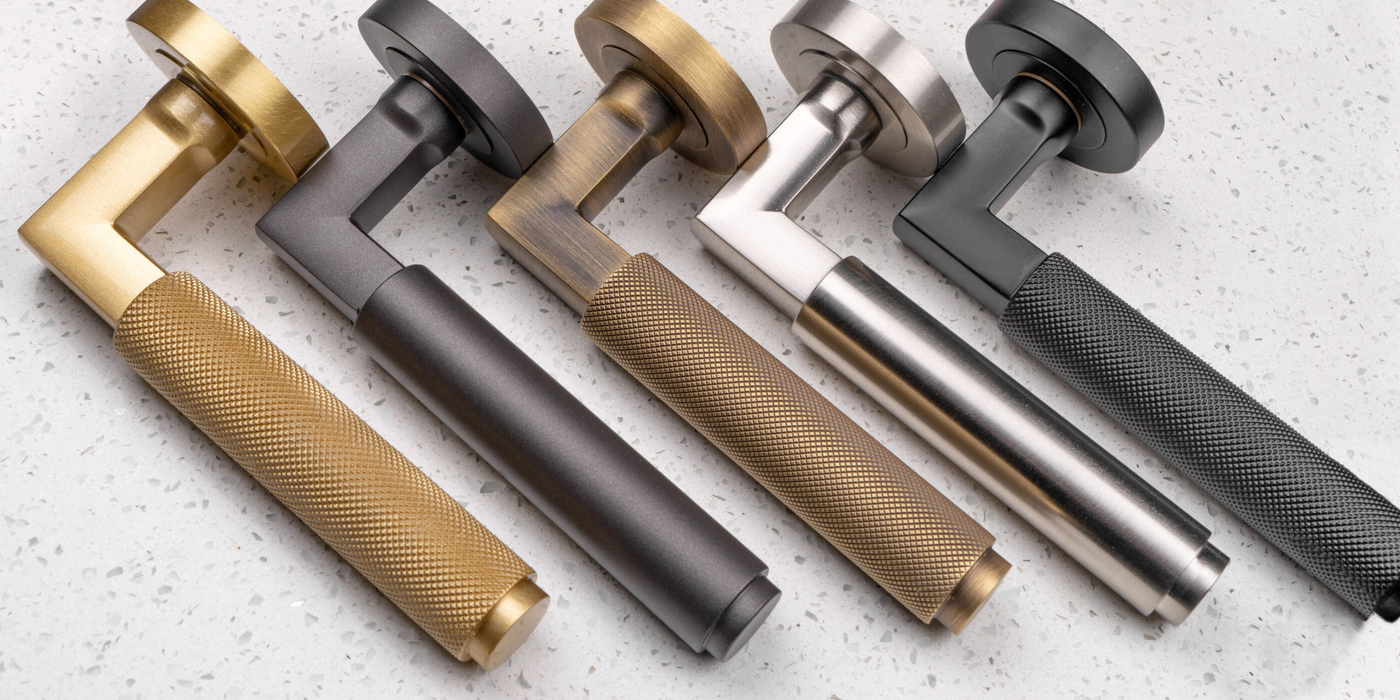 This is an image showing a range of door handles on round roses in various finishes from Carlisle Brass, available to order from T.H Wiggans Ironmongery in Kendal