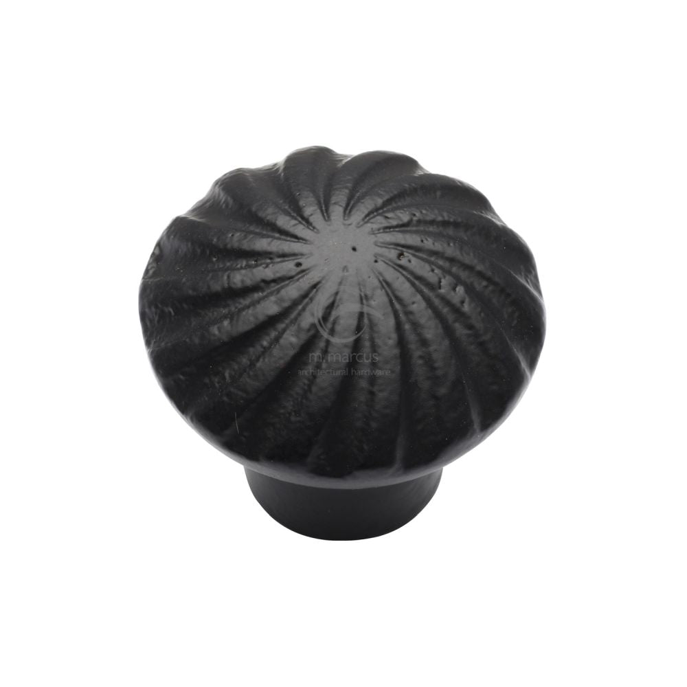 This is an image of a M.Marcus - Black Iron Rustic Cabinet Knob Wheel Design 32mm, fb3891-32 that is available to order from T.H Wiggans Ironmongery in Kendal.