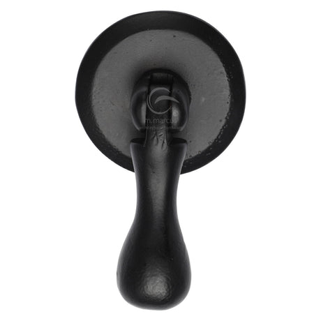 This is an image of a M.Marcus - Matt Black Rustic Iron Cabinet Drop Pull On Round Plate, fb6264 that is available to order from T.H Wiggans Ironmongery in Kendal.