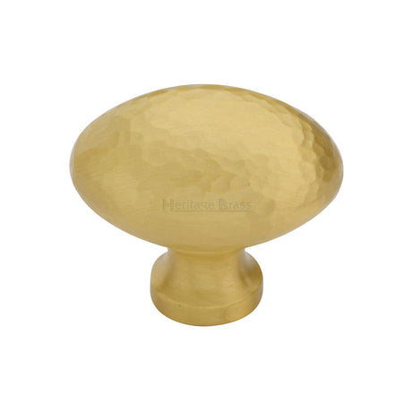 This is an image of a Heritage Brass - Cabinet Knob Victorian Oval Hammered Design 38mm Satin Brass finish, ham114-38-sb that is available to order from T.H Wiggans Ironmongery in Kendal.
