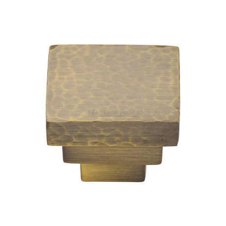This is an image of a Heritage Brass - Cabinet Knob Square Stepped Hammered Design 32mm Antique Brass finish, ham3672-32-at that is available to order from T.H Wiggans Ironmongery in Kendal.