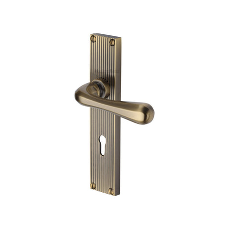 This is an image of a Heritage Brass - Charlbury Reeded Lever Lock Antique Brass finish, rr3000-at that is available to order from T.H Wiggans Ironmongery in Kendal.