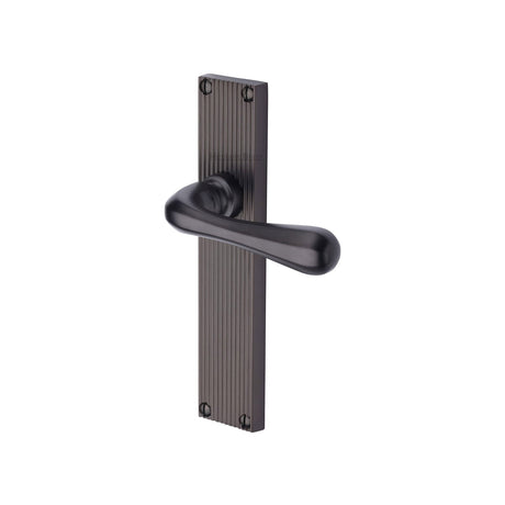 This is an image of a Heritage Brass - Charlbury Reeded Lever Latch Matt Bronze finish, rr3010-mb that is available to order from T.H Wiggans Ironmongery in Kendal.