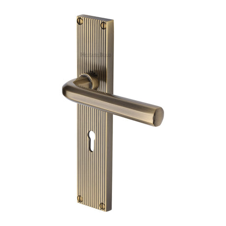 This is an image of a Heritage Brass - Octave Reeded Lever Lock Antique Brass finish, rr3700-at that is available to order from T.H Wiggans Ironmongery in Kendal.