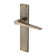 This is an image of a Heritage Brass - Gio Reeded Lever Latch Antique Brass finish, rr4710-at that is available to order from T.H Wiggans Ironmongery in Kendal.
