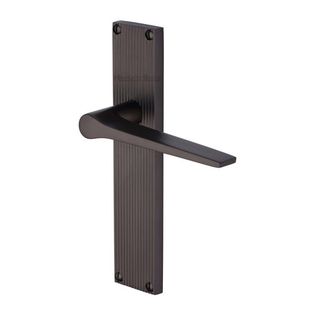 This is an image of a Heritage Brass - Gio Reeded Lever Latch Matt Bronze finish, rr4710-mb that is available to order from T.H Wiggans Ironmongery in Kendal.