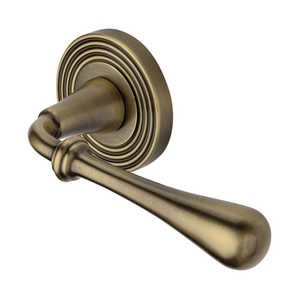 This is an image of a Heritage Brass - Door Handle Lever Latch on Round Rose Roma Reeded Design Antique B, rr7156-at that is available to order from T.H Wiggans Ironmongery in Kendal.