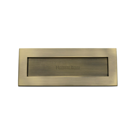 This is an image of a Heritage Brass - Reeded Letterplate 10" x 4" Antique Brass finish, rr852-254-101-at that is available to order from T.H Wiggans Ironmongery in Kendal.