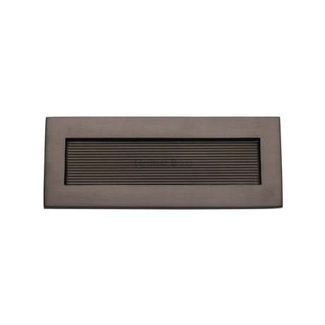 This is an image of a Heritage Brass - Reeded Letterplate 10" x 4" Matt Bronze finish, rr852-254-101-mb that is available to order from T.H Wiggans Ironmongery in Kendal.