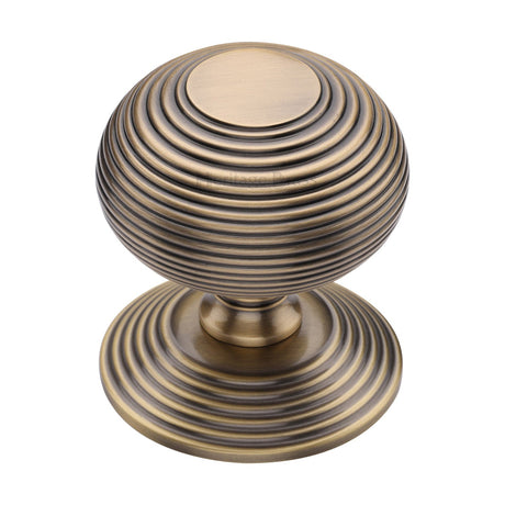 This is an image of a Heritage Brass - Centre Door Knob Reeded Design 3 1/2 Antique Brass Finish, rr906-at that is available to order from T.H Wiggans Ironmongery in Kendal.