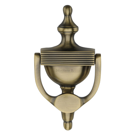 This is an image of a Heritage Brass - Urn Knocker 7 1/4" Antique Brass finish, rr912-195-at that is available to order from T.H Wiggans Ironmongery in Kendal.