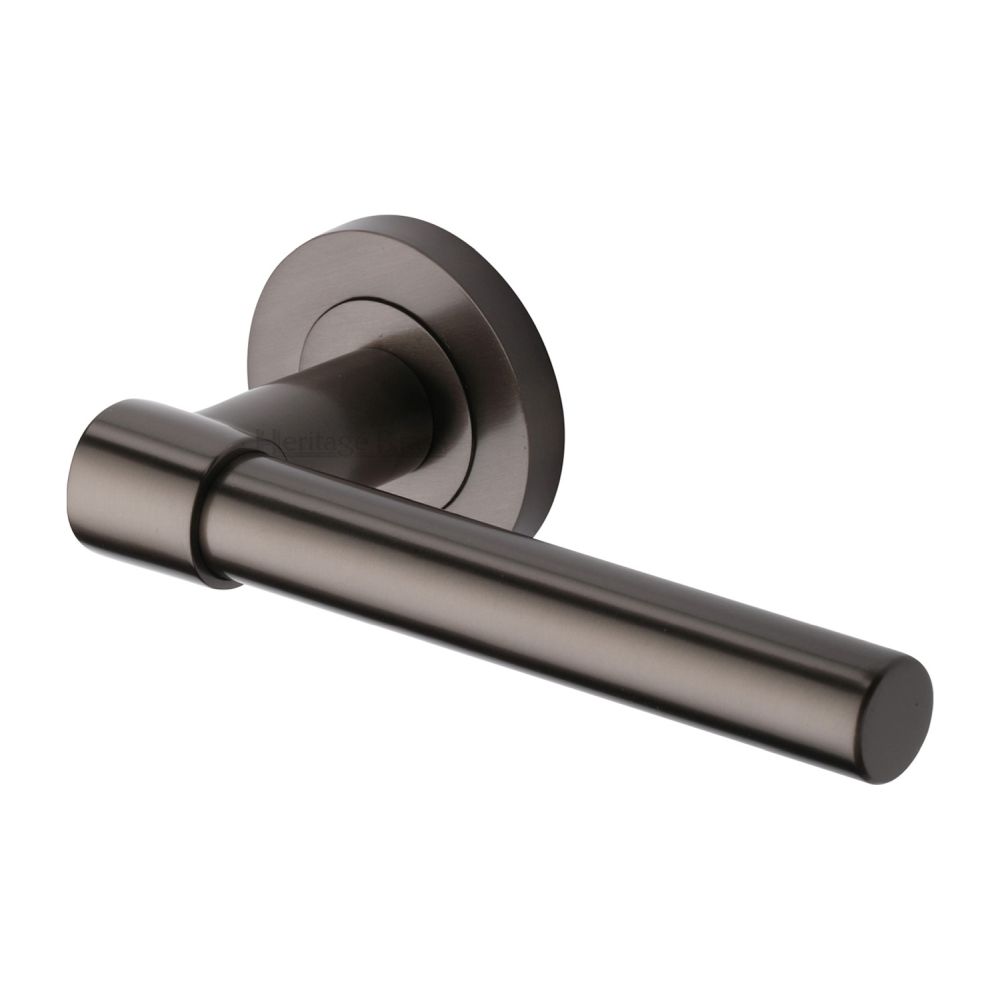 This is an image of a Heritage Brass - Door Handle Lever on Rose Phoenix Design Matt Bronze Finish, rs2017-mb that is available to order from T.H Wiggans Ironmongery in Kendal.