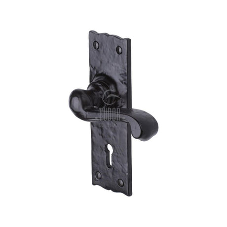 This is an image of a The Tudor Collection - Door Handle Lever Lock Shropshire Design Black Iron, tc100 that is available to order from T.H Wiggans Ironmongery in Kendal.
