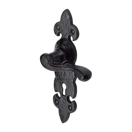 This is an image of a The Tudor Collection - Door Handle Lever Lock Fleur de Lys Design Black Iron, tc200 that is available to order from T.H Wiggans Ironmongery in Kendal.