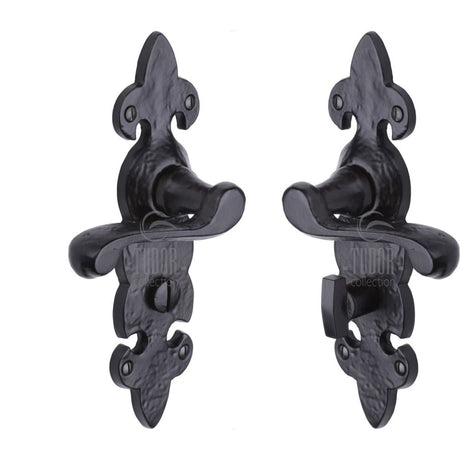This is an image of a The Tudor Collection - Door Handle for Bathroom Fleur de Lys Design Black Iron, tc220 that is available to order from T.H Wiggans Ironmongery in Kendal.
