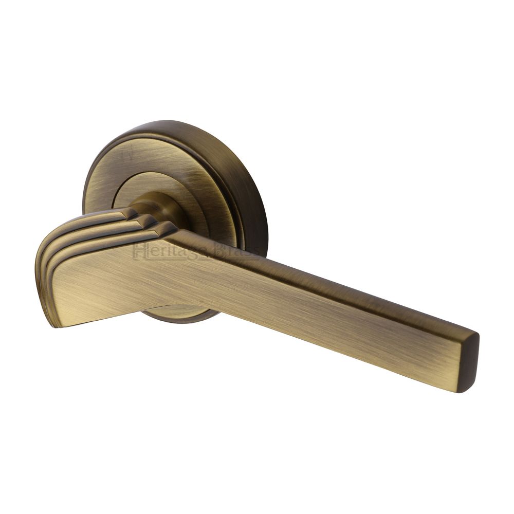 This is an image of a Heritage Brass - Door Handle Lever on Rose Tiffany Design Antique Brass Finish, tif1926-at that is available to order from T.H Wiggans Ironmongery in Kendal.