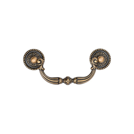 This is an image of a M.Marcus - Ornate Drop Pull 96mm Distressed Brass Finish, tk3085-096-dbs that is available to order from T.H Wiggans Ironmongery in Kendal.