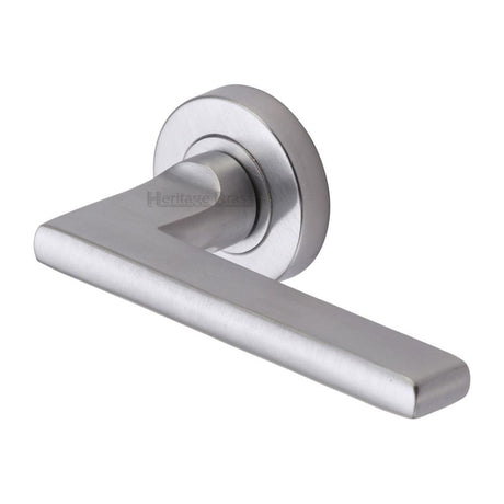 This is an image of a Heritage Brass - Door Handle Lever Latch on Round Rose Trident Design Satin Chrom, tri1352-sc that is available to order from T.H Wiggans Ironmongery in Kendal.