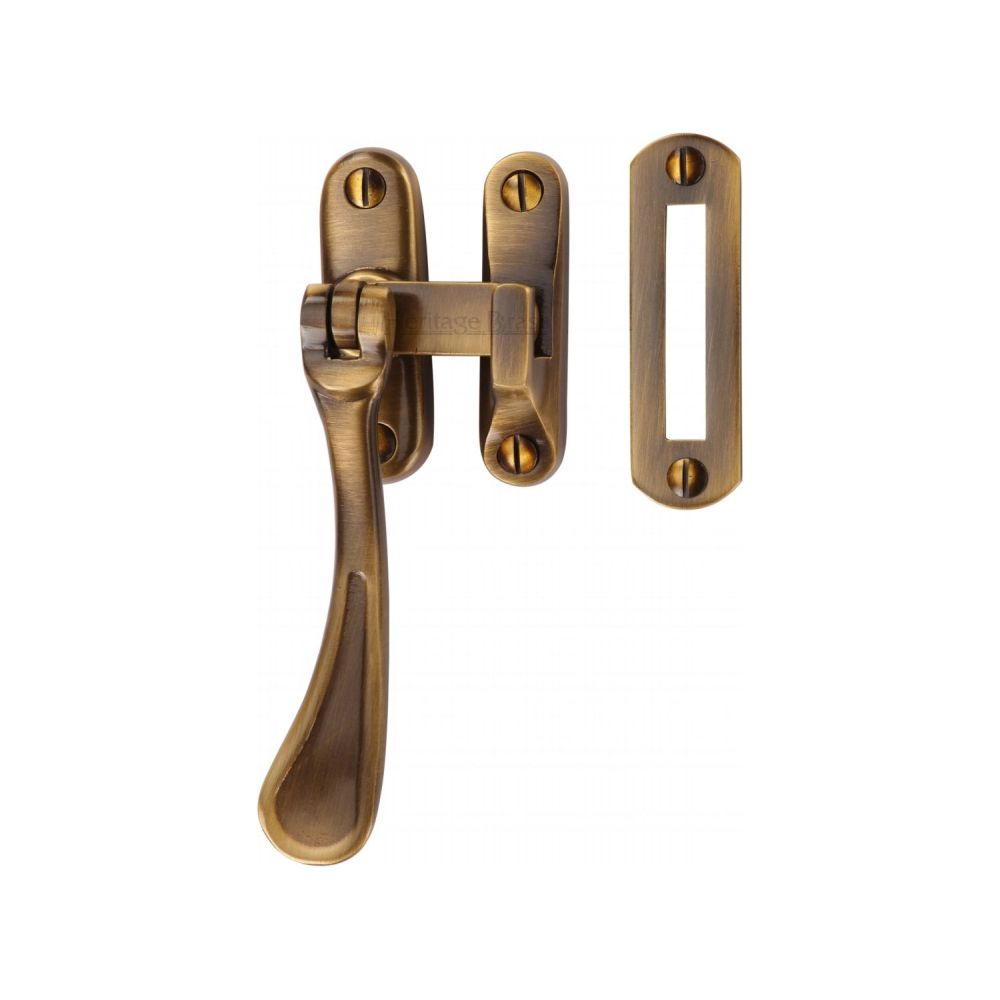 This is an image of a Heritage Brass - Casement Window Fastener Spoon Pattern Antique Brass Finish, v1003-mp-hp-at that is available to order from T.H Wiggans Ironmongery in Kendal.