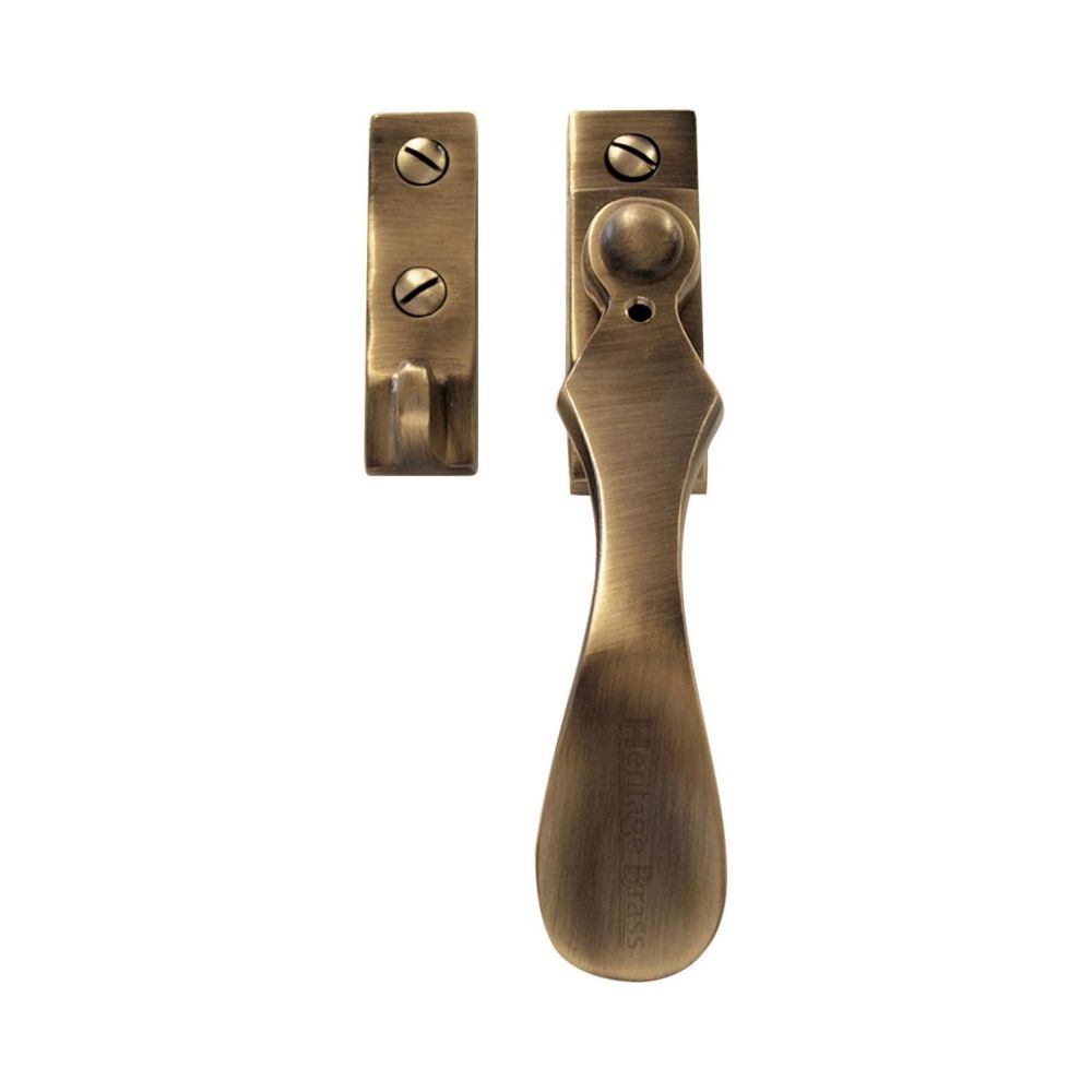 This is an image of a Heritage Brass - Casement Window Fastener Wedge Pattern Antique Brass Finish, v1005-at that is available to order from T.H Wiggans Ironmongery in Kendal.