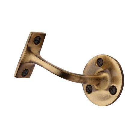 This is an image of a Heritage Brass - Handrail Bracket 2 1/2" Antique Brass Finish, v1030-64-at that is available to order from T.H Wiggans Ironmongery in Kendal.