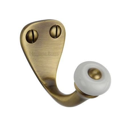 This is an image of a Heritage Brass - Single Robe Hook Antique Brass Finish, v1044-at that is available to order from T.H Wiggans Ironmongery in Kendal.