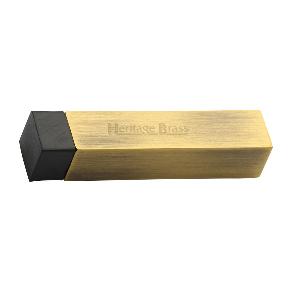 This is an image of a Heritage Brass - Door Stop Square Wall Mounted Design Antique Brass Finish, v1084-at that is available to order from T.H Wiggans Ironmongery in Kendal.