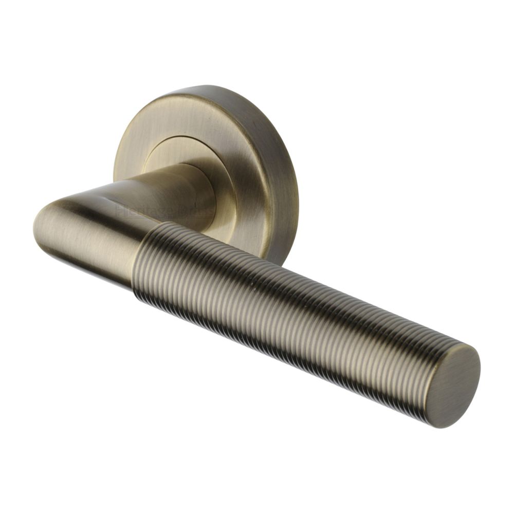 This is an image of a Heritage Brass - Door Handle Lever Latch on Round Rose Bauhaus Mitre Reeded Desi, v2274-at that is available to order from T.H Wiggans Ironmongery in Kendal.