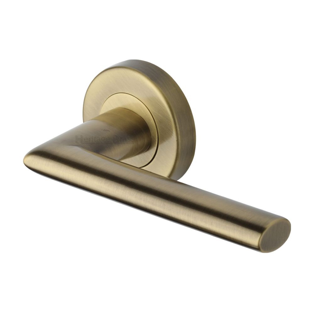 This is an image of a Heritage Brass - Door Handle Lever Latch on Round Rose Admiralty Design Antique Bra, v2355-at that is available to order from T.H Wiggans Ironmongery in Kendal.